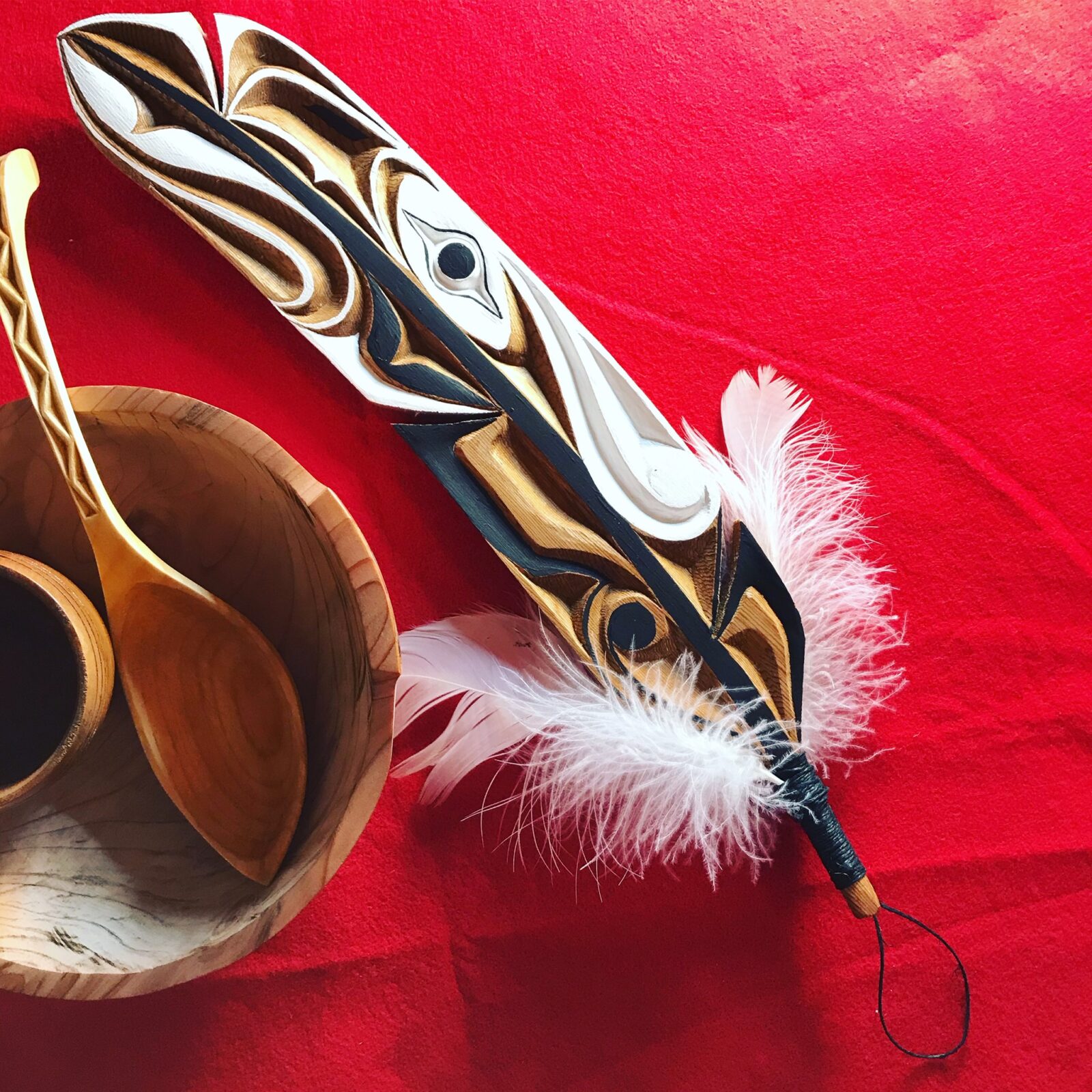 Carved feather on a red background